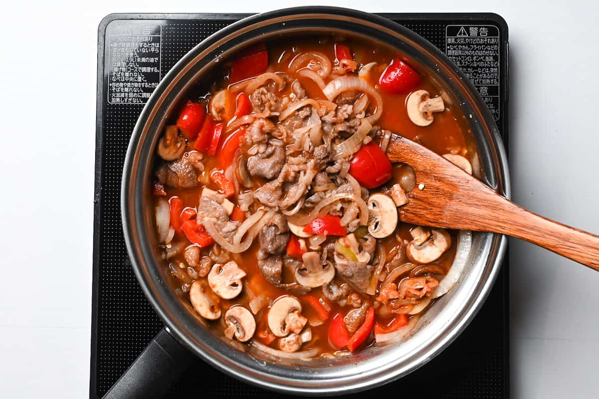 Hayashi rice simmering in a pan with beef stock