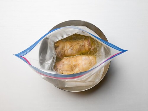 chicken chashu in a ziplock bag with broth