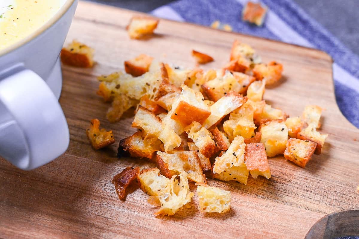 Homemade croutons on a wooden chopping board