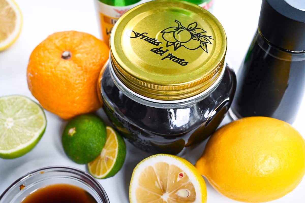 ponzu sauce in a glass jar surrounded by citrus fruits