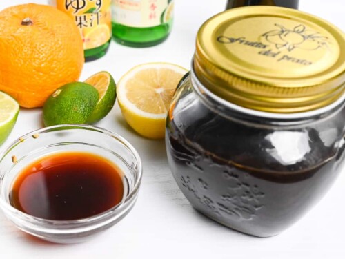Ponzu sauce stored in a glass jar next to a glass dipping bowl