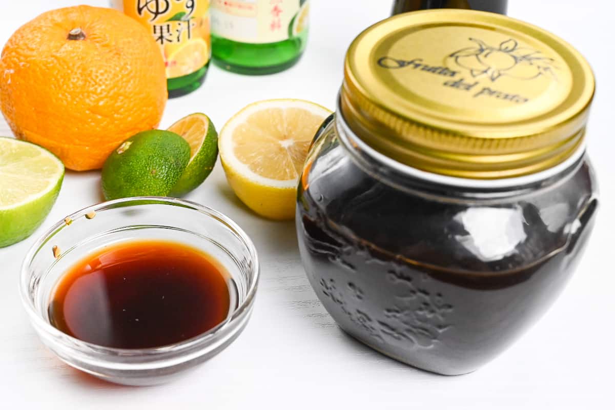 Ponzu sauce stored in a glass jar next to a glass dipping bowl