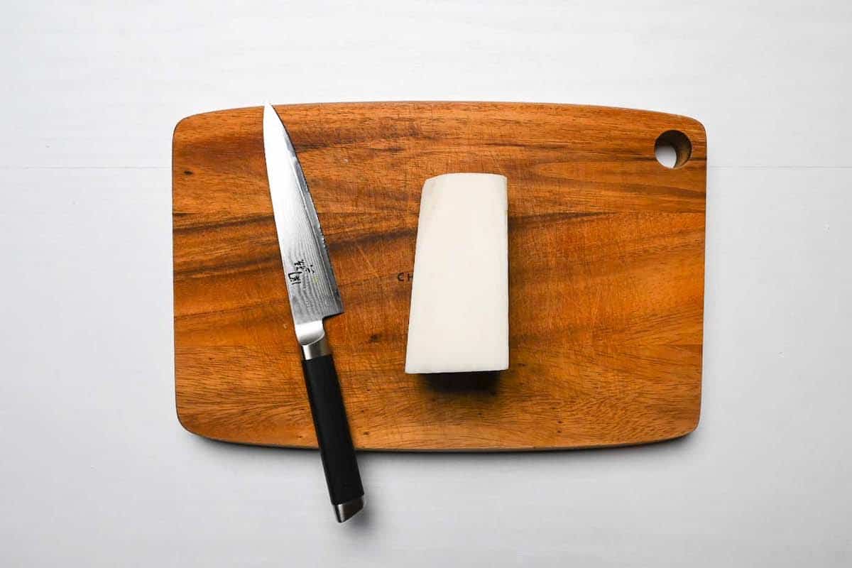 A block of daikon on a wooden chopping board