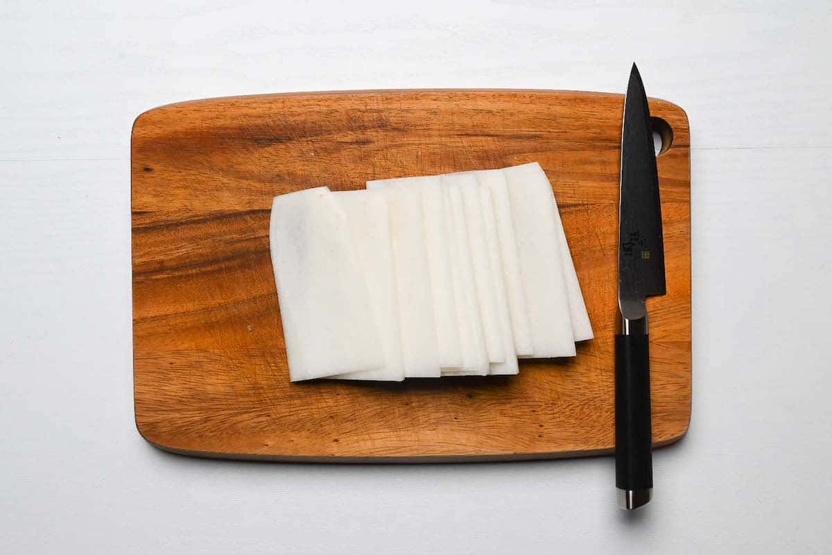 slices of daikon on a wooden chopping board