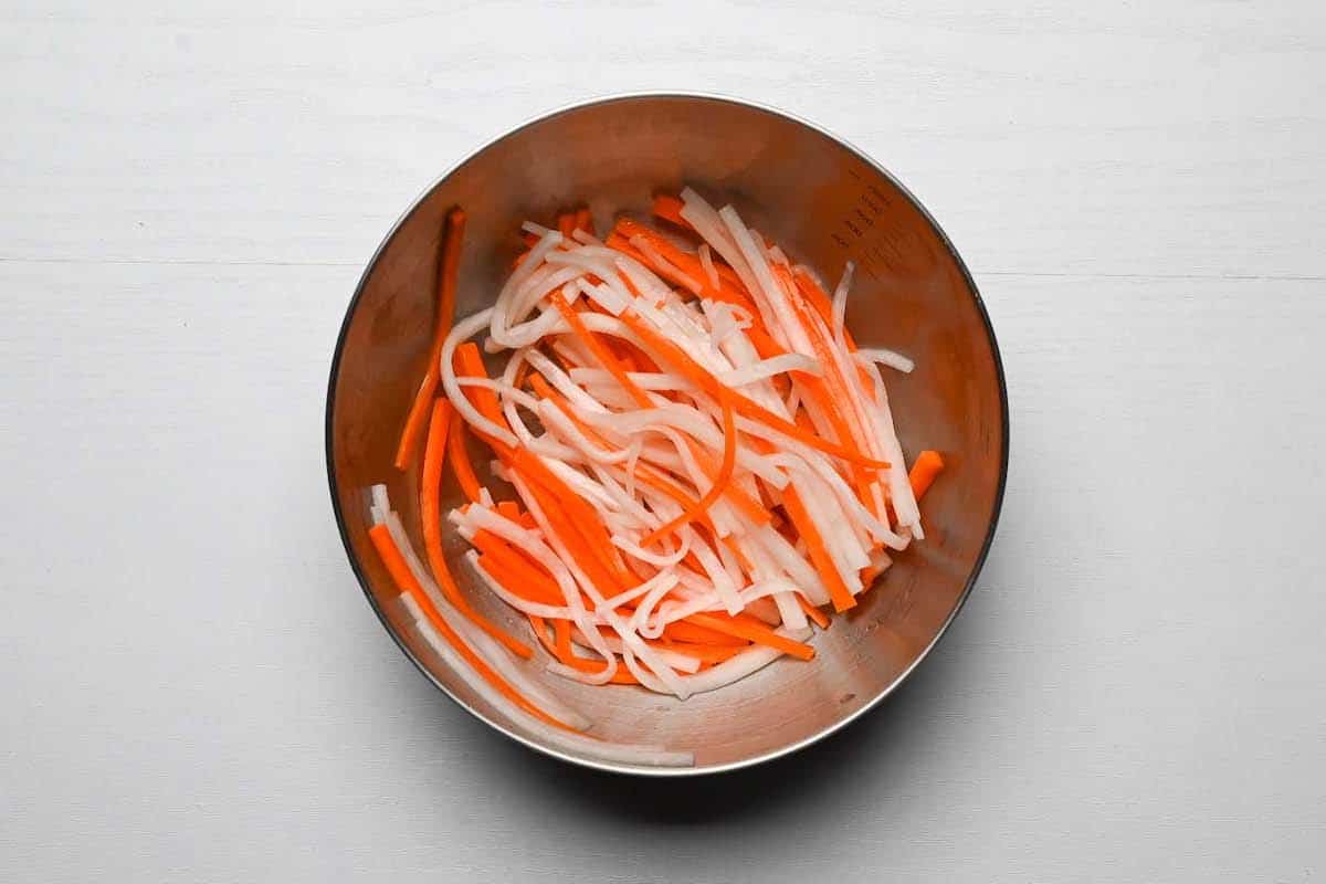 daikon and carrot strips mixed in a bowl