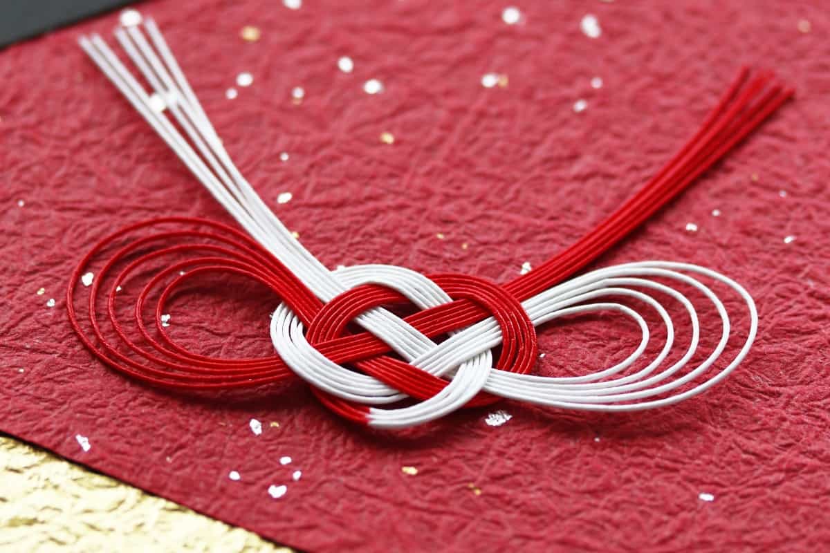 Japanese red and white "mizuhiki" on red paper sprinkled with gold