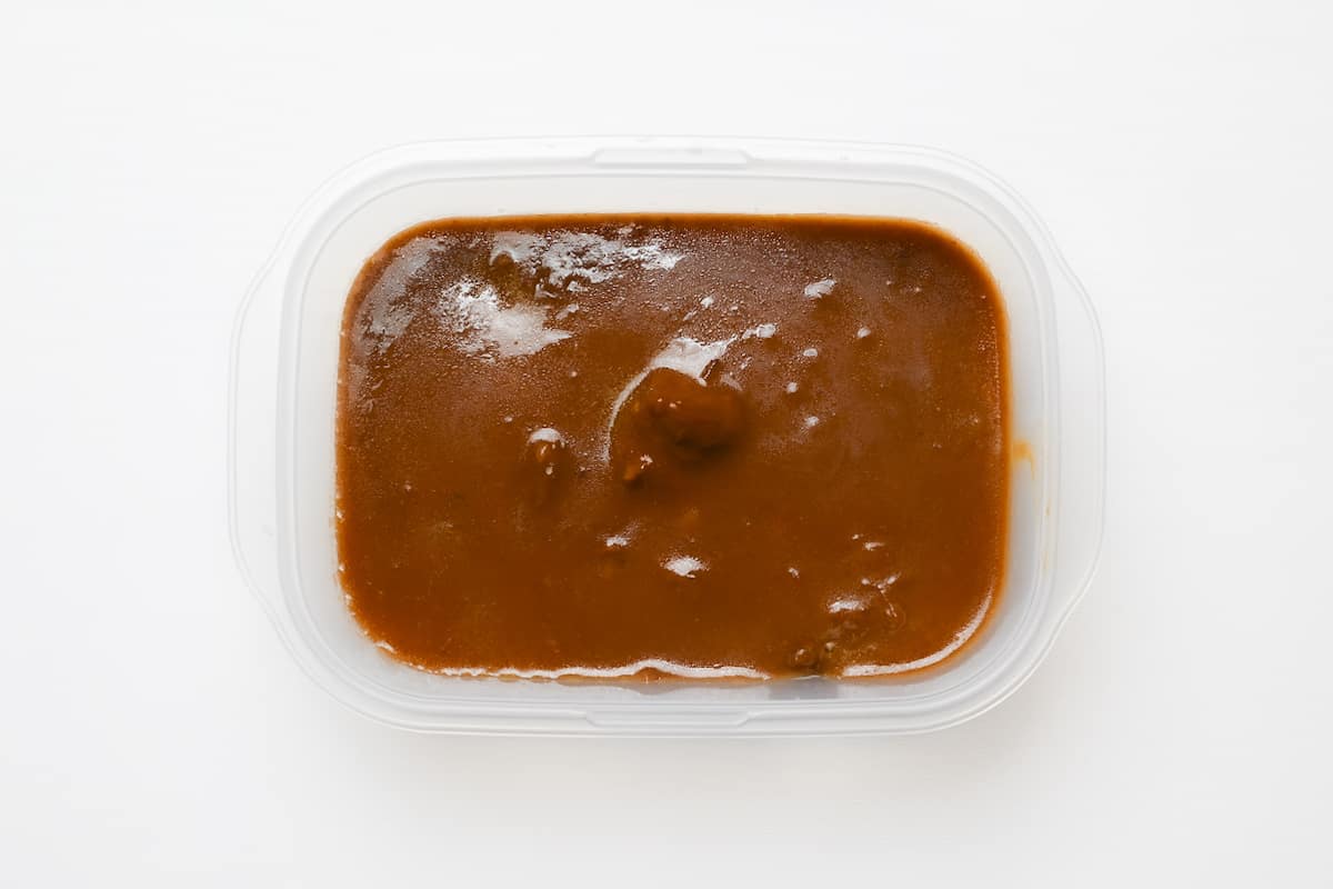 Japanese curry with potatoes and carrots removed ready in a freezer-proof container for freezing