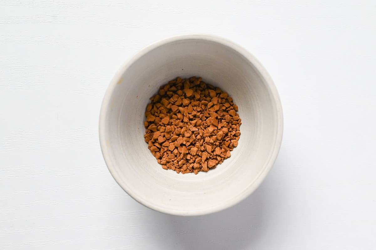 Instant coffee granules in a small white ceramic bowl