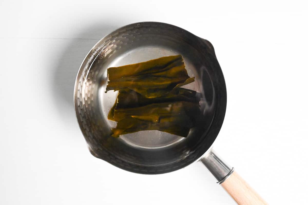 Kombu (dried kelp) soaking in a pan of water
