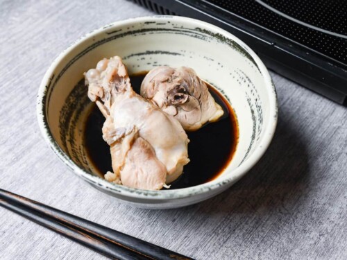 Chicken thigh and drumsticks in a bowl of ponzu