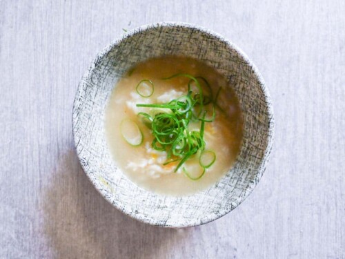 Rice and egg in mizutaki broth topped with chopped spring onion