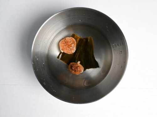 Kombu and shiitake dashi in a bowl with water