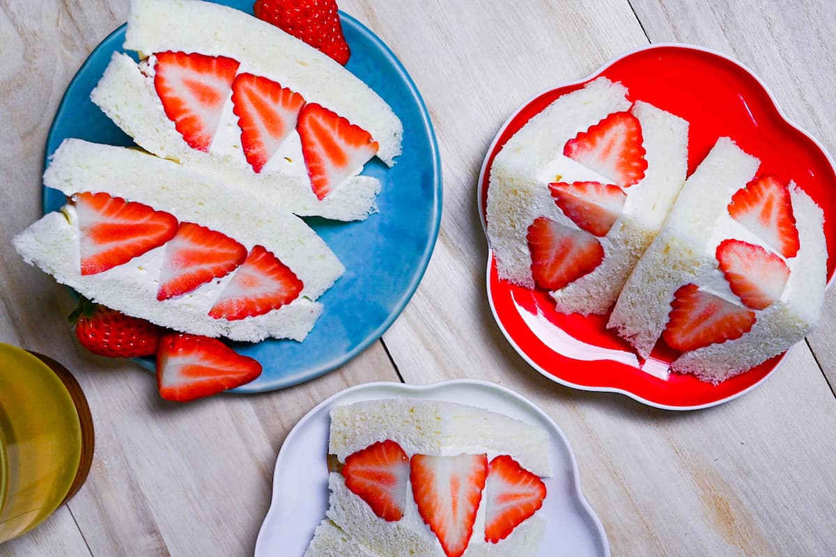 Japanese ichigo sando (strawberry sandwiches) served in various plates (top down view)