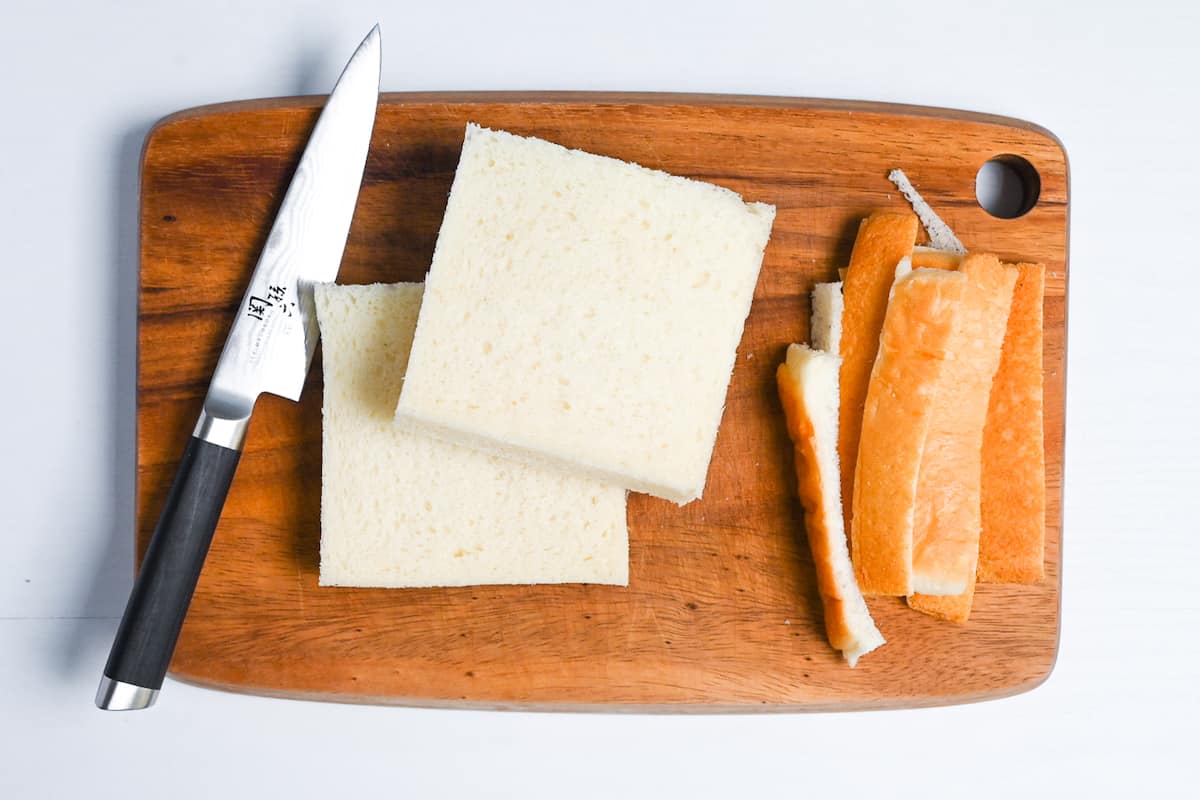 shokupan (Japanese milk bread) with the crusts cut off on a wooden chopping board