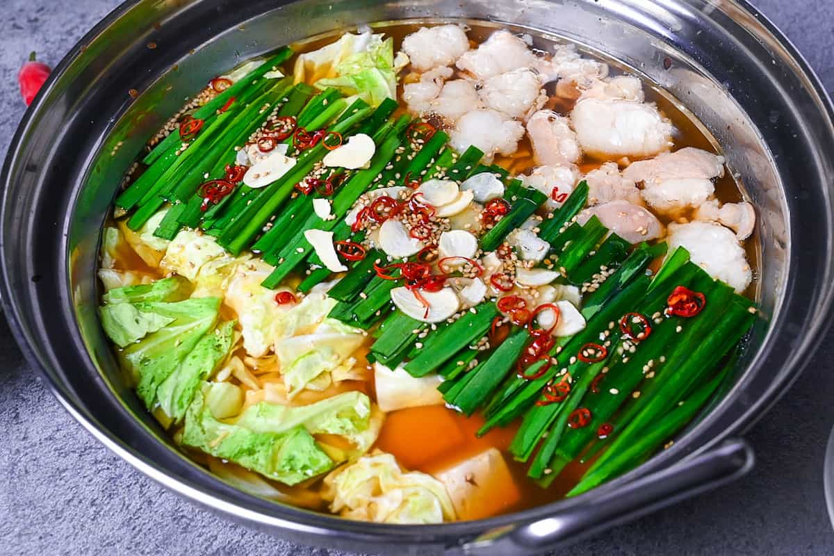 Motsunabe in an aluminum pot made with beef intestines, cabbage and tofu served in an aluminum pot