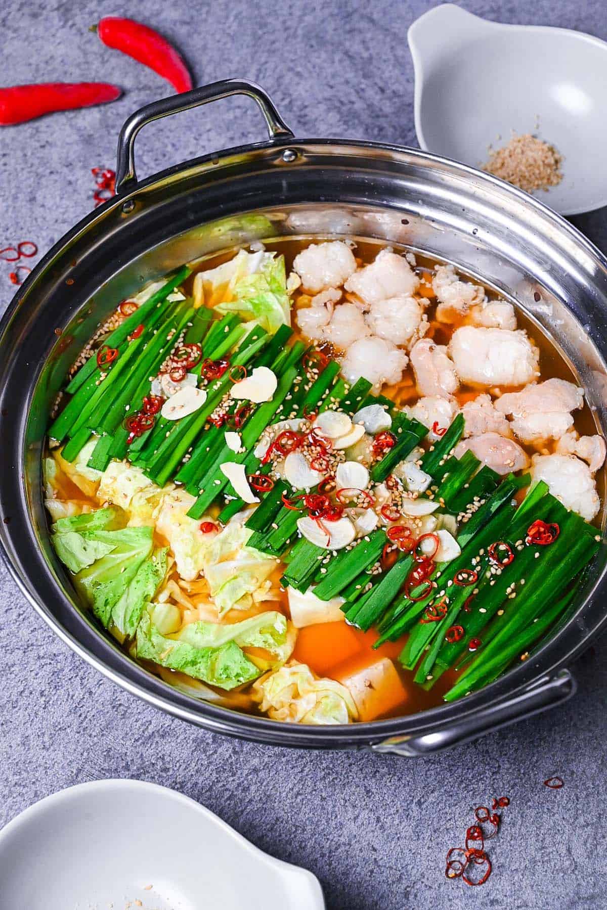 Motsunabe in an aluminum pot made with beef intestines, cabbage and tofu served in an aluminum pot