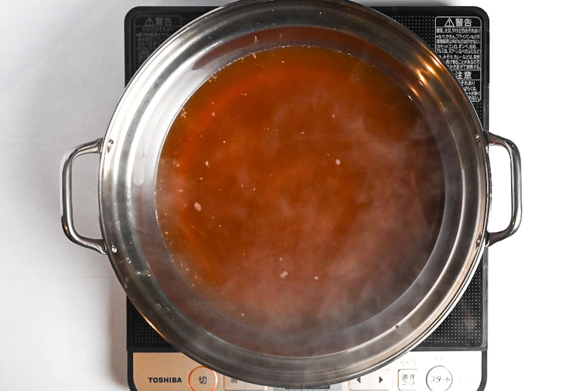 Homemade motsunabe broth in an aluminum pot