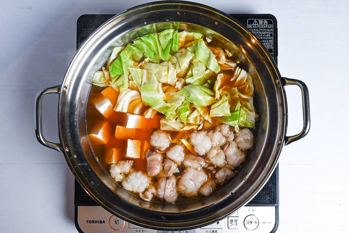 Motsunabe in an aluminum pot made with beef intestines, cabbage and tofu