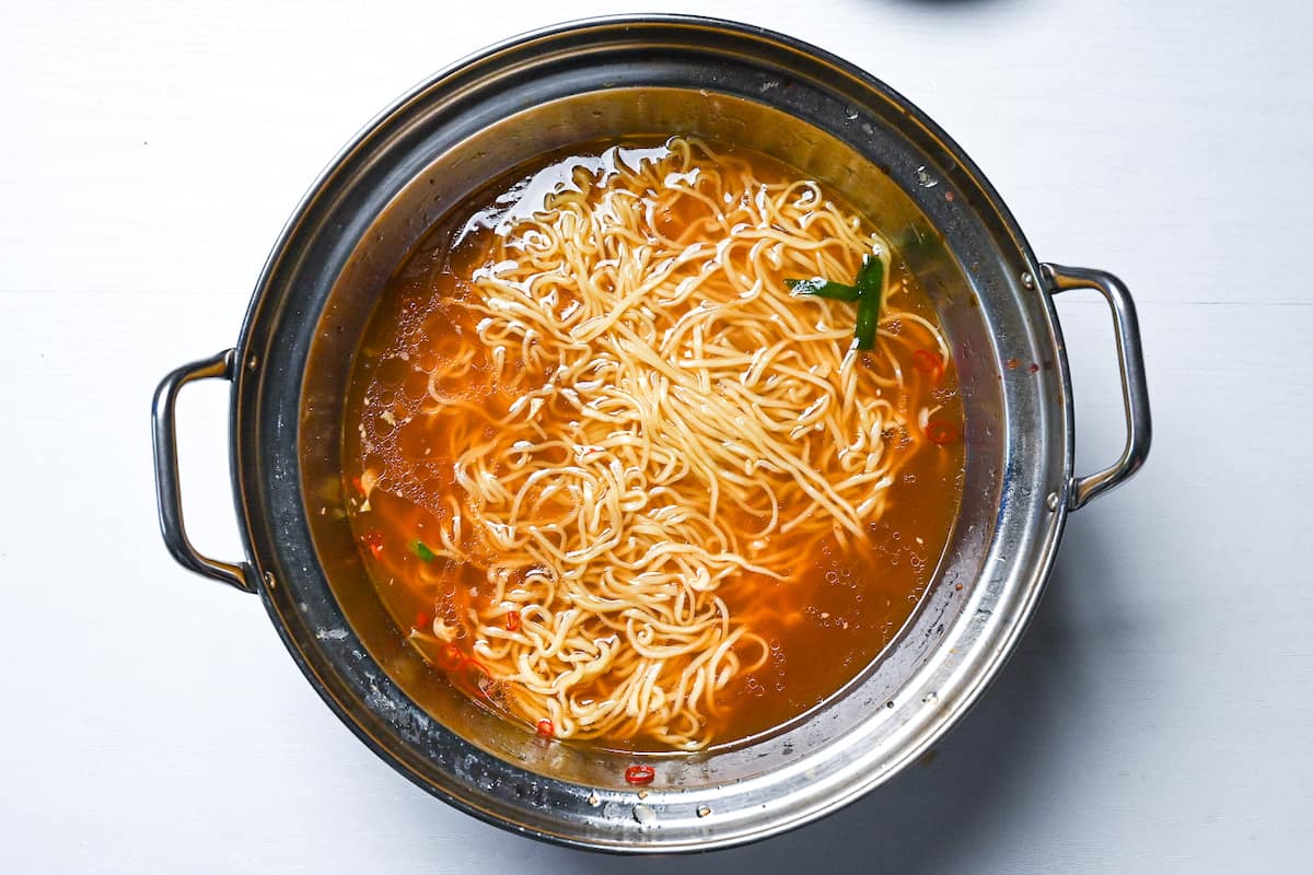 Ramen noodles served in leftover motsunabe broth