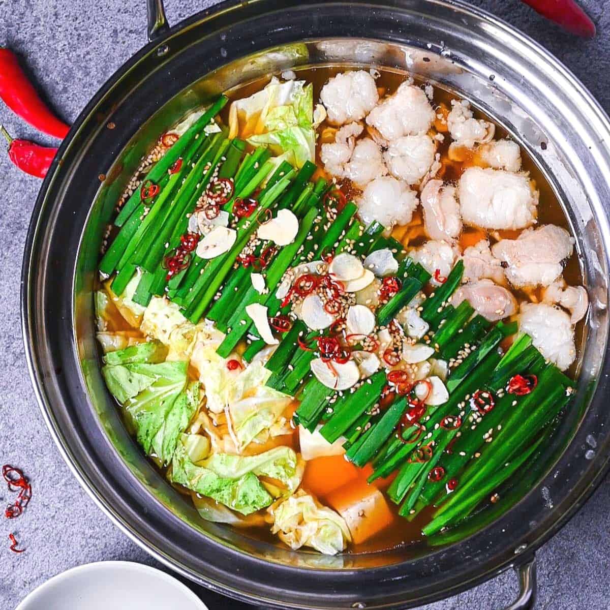 Motsunabe in an aluminum pot made with beef intestines, cabbage and tofu served in an aluminum pot