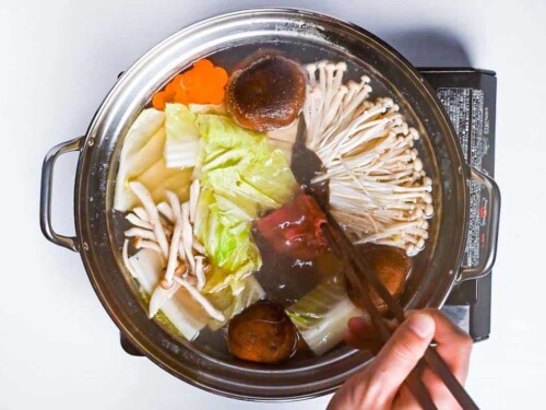 Cooking beef in the shabu shabu pot with vegetables