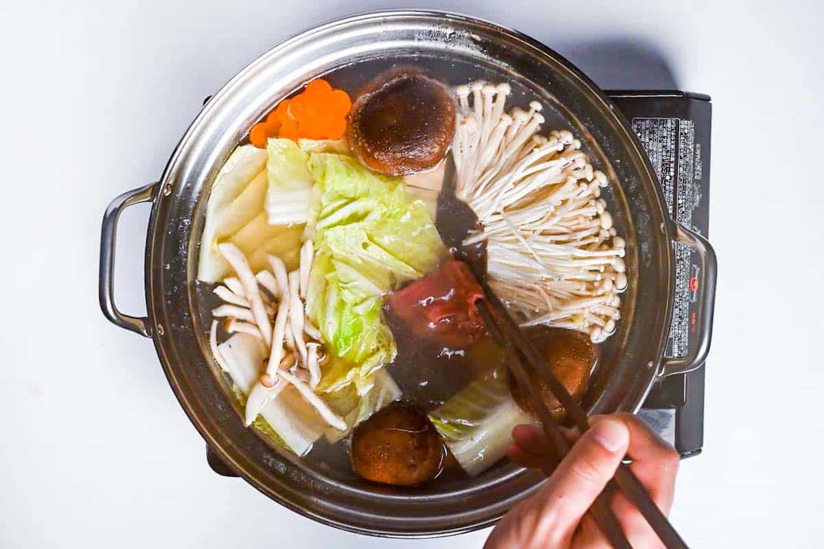 Cooking beef in the shabu shabu pot with vegetables