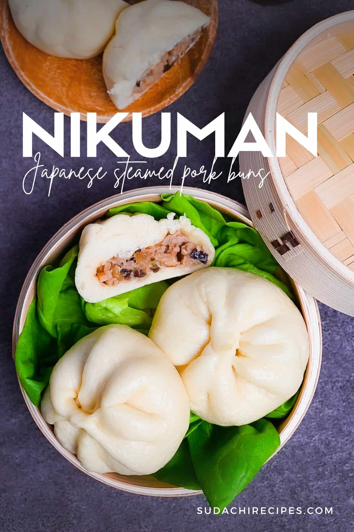 Japanese "nikuman" steamed pork buns in a bamboo steamer arranged over green frilly lettuce