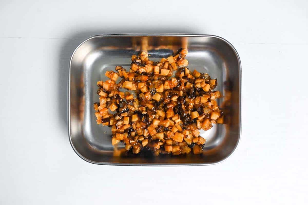 sautéed vegetables cooling in a metal container