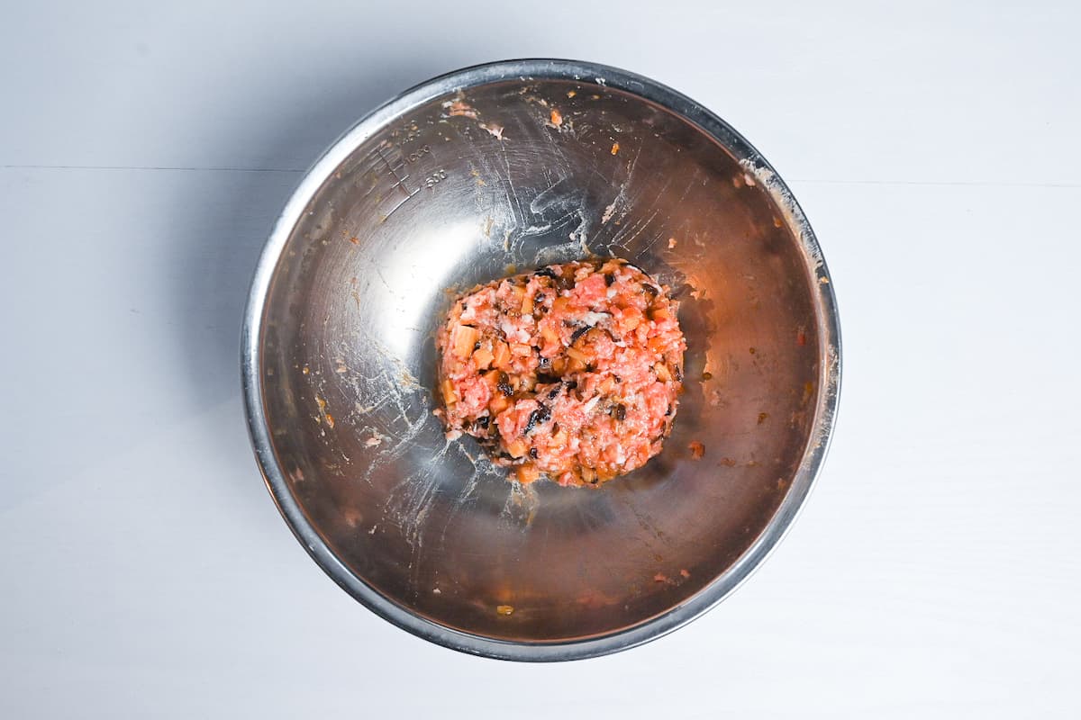 nikuman filling made with pork and sautéed vegetables in a mixing bowl