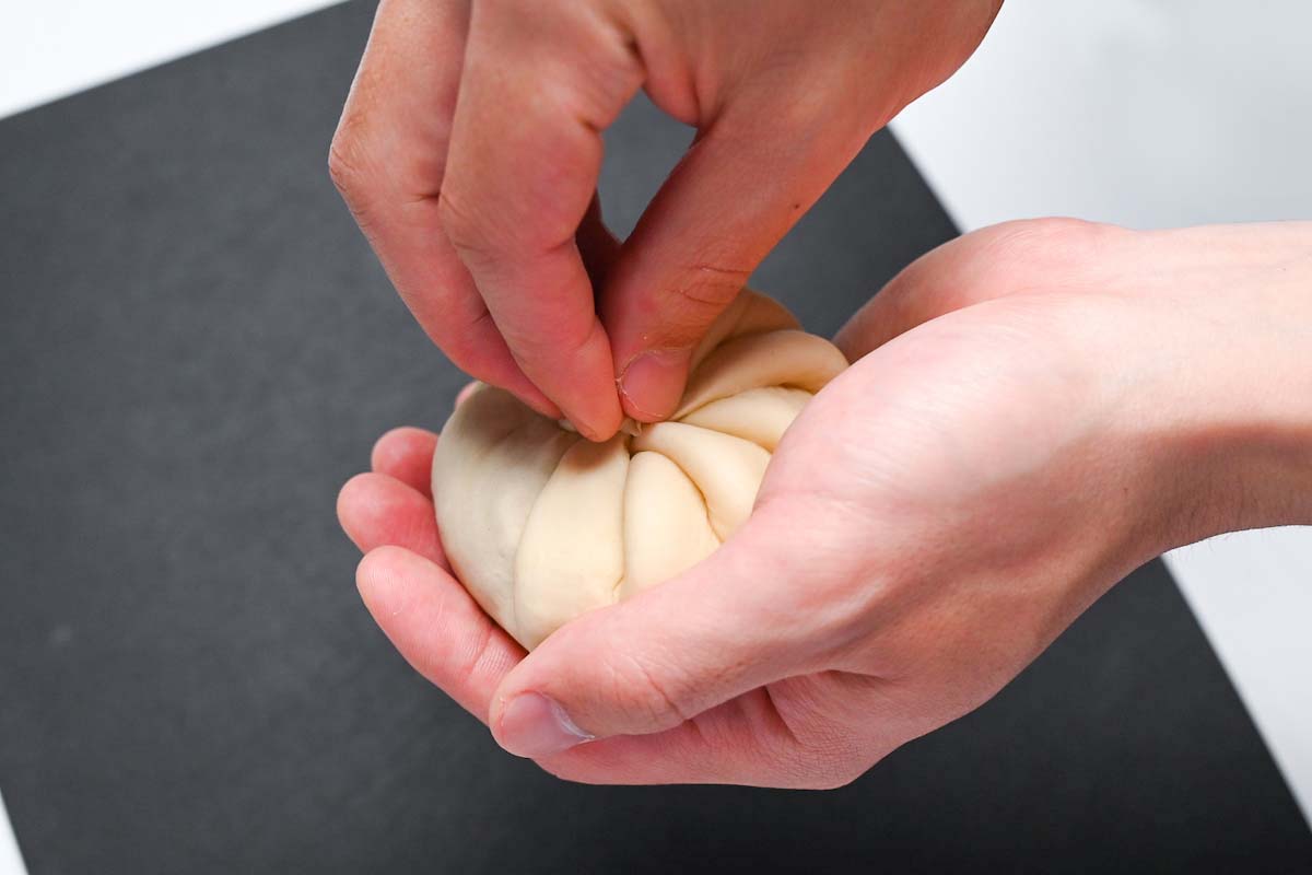 twisting the top of nikuman dough to close