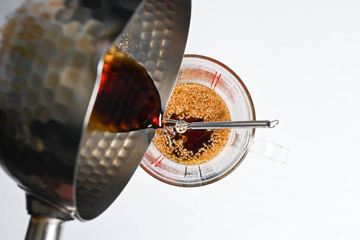 Pouring cooked mixture into jug for Japanese chicken salad