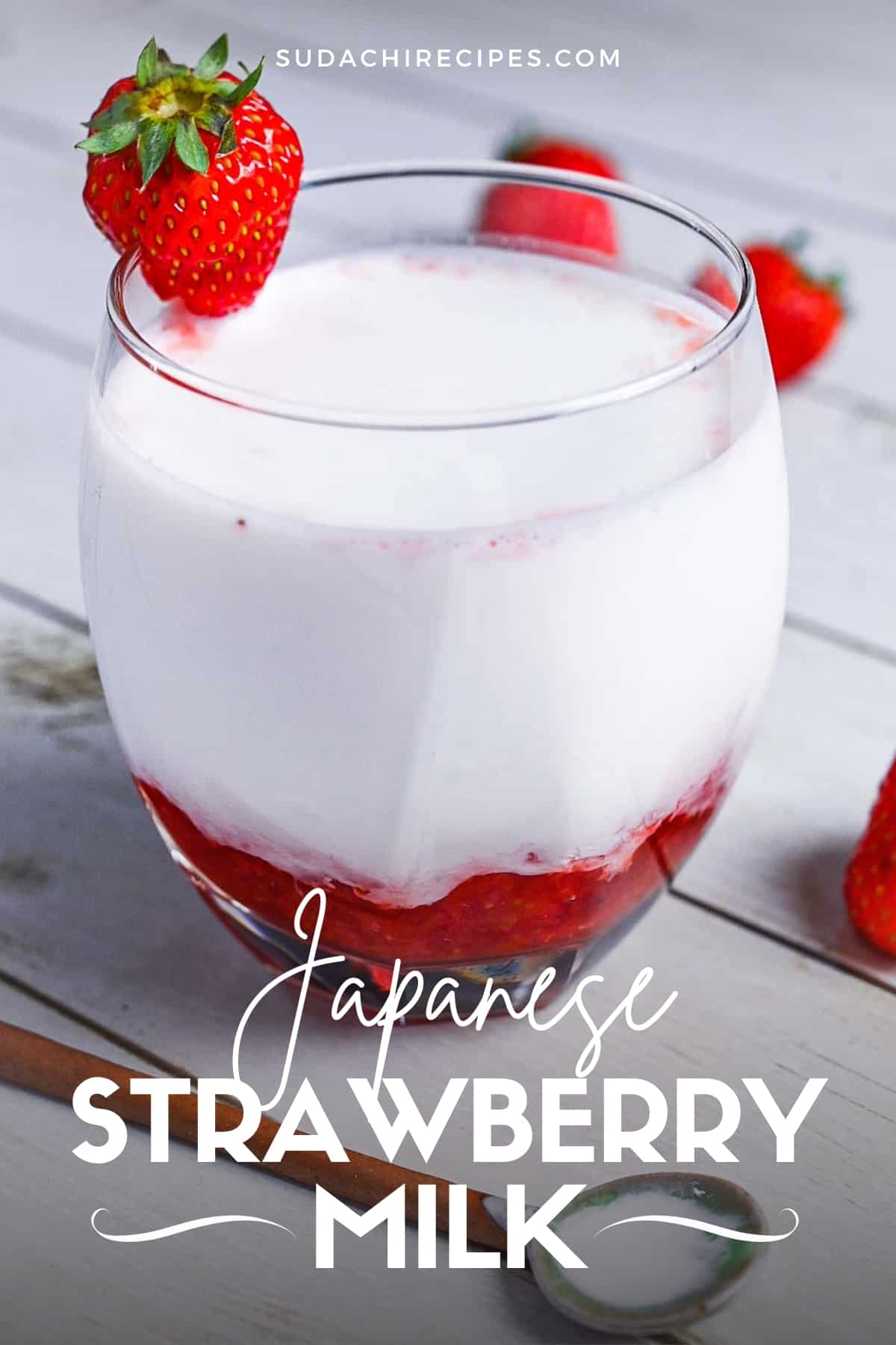 Japanese strawberry milk in a glass with a strawberry on the rim
