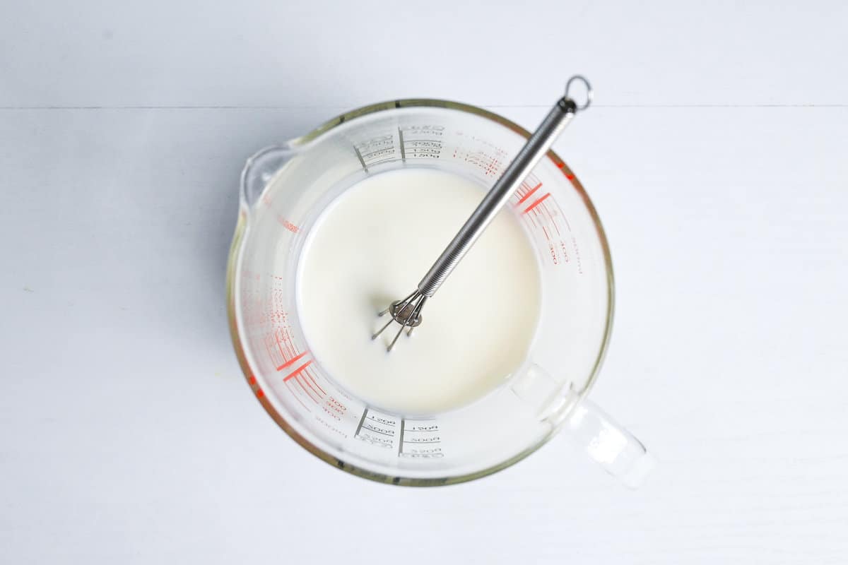 Milk, condensed milk and cream combined in a glass measuring jug