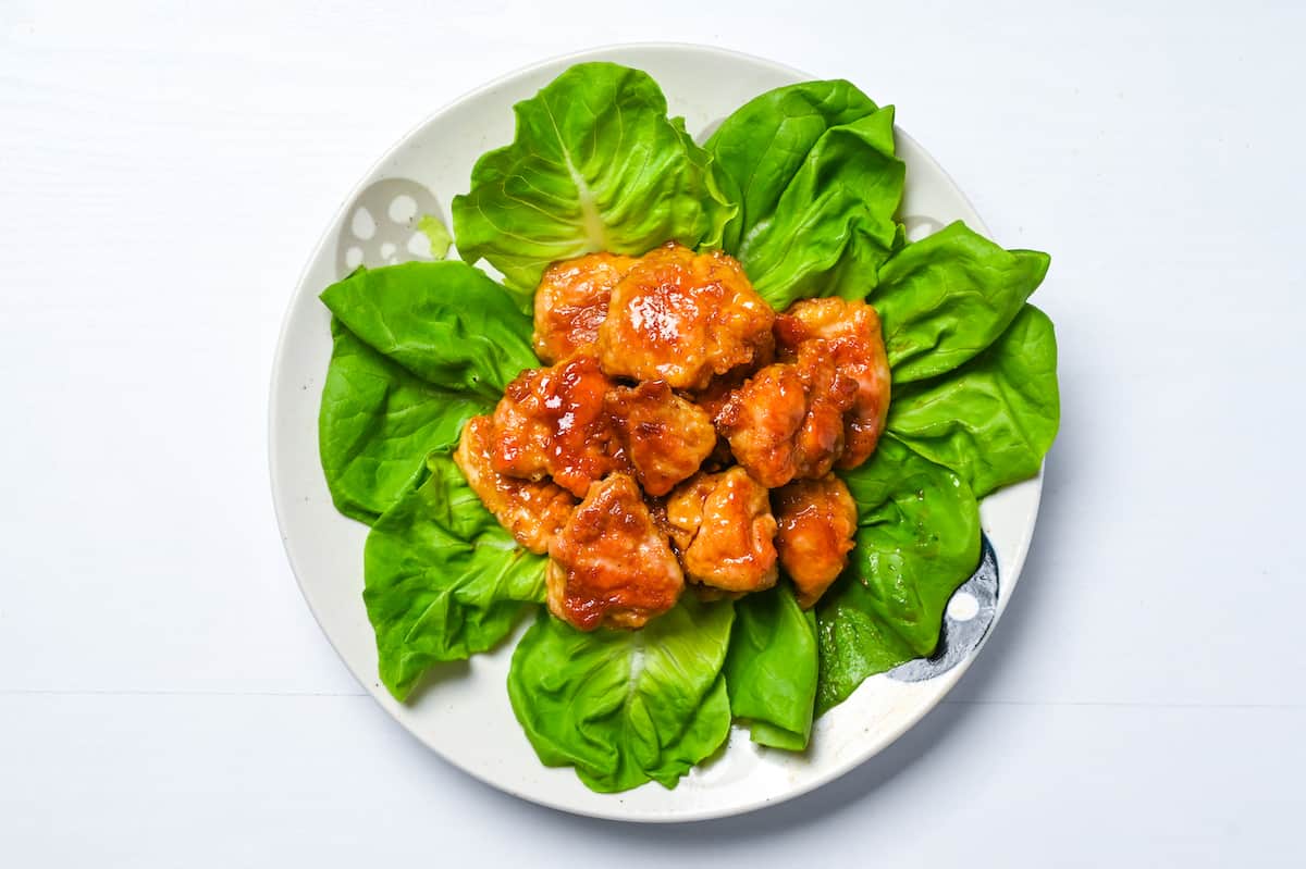 Chicken nanban stacked on top of lettuce leaves