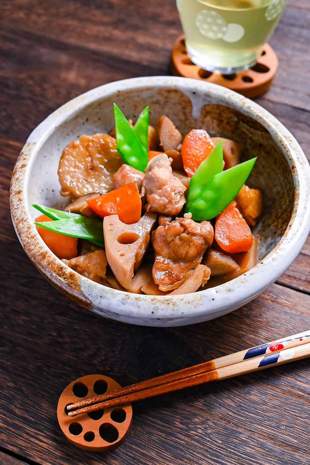 Chikuzenni (Japanese simmered chicken and vegetables) served in a mottled beige bowl