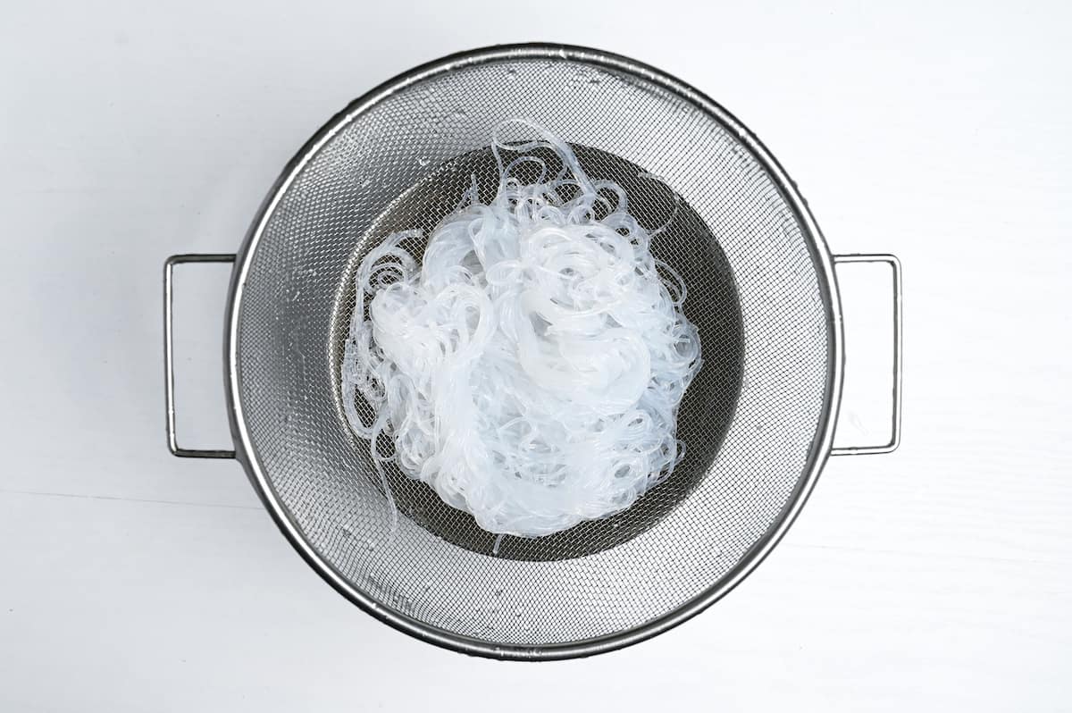 Glass noodles drained and washed in a sieve