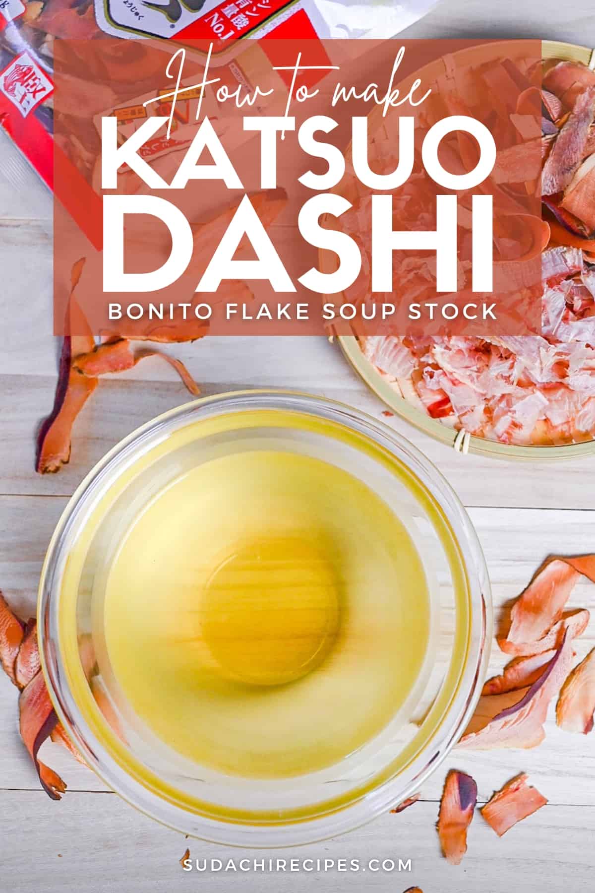 Kasuobushi (bonito flake) dashi in a glass bowl surrounded by bonito flakes