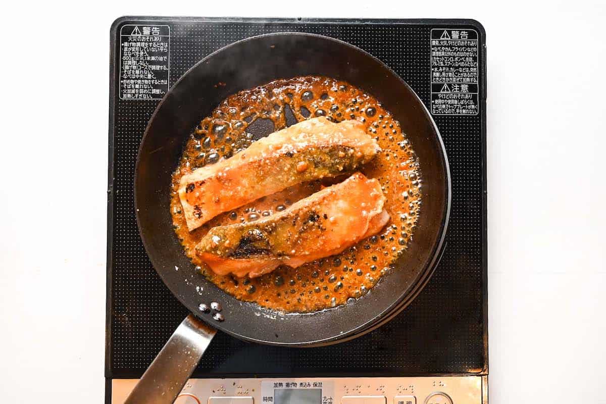 Salmon fillets with miso glaze cooking in residual heat