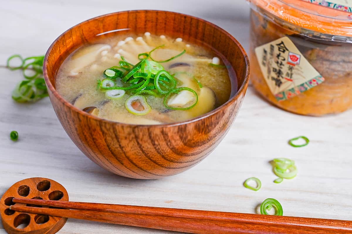 Mushroom miso soup made with 4 kinds of mushroom served in a wooden bowl side view