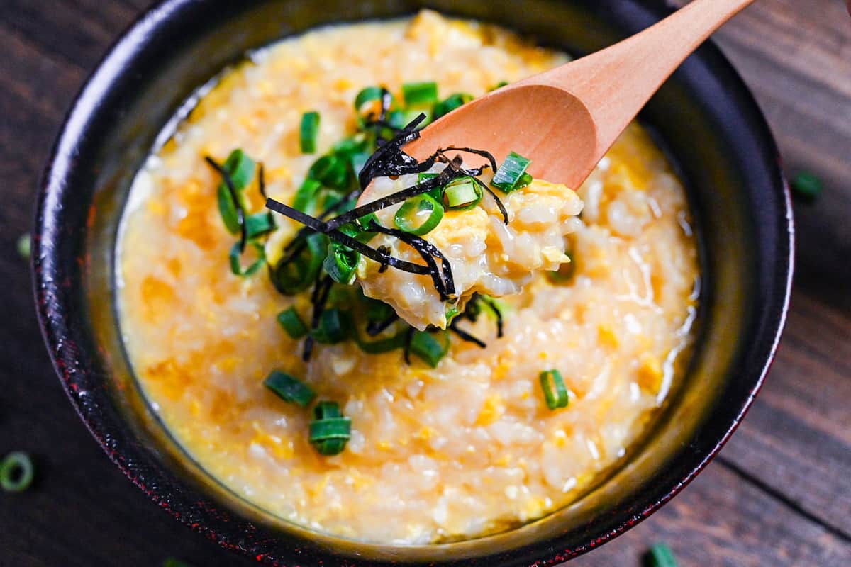 Japanese rice porridge (okayu) on a wooden spoon