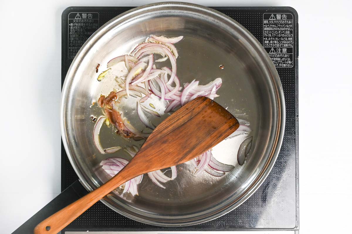 Frying red onion and anchovy in garlic-infused oil