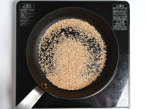 sesame seeds roasting in a pan