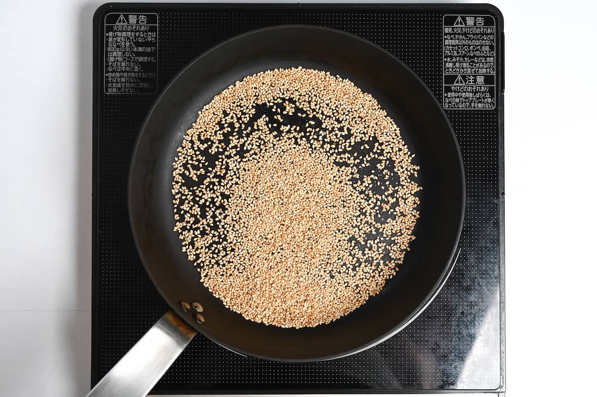 sesame seeds roasting in a pan