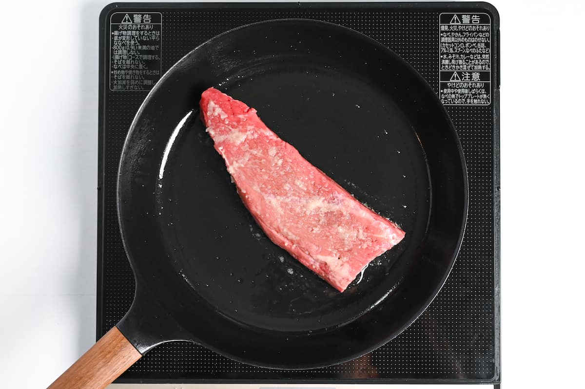 searing fillet of beef in an iron skillet