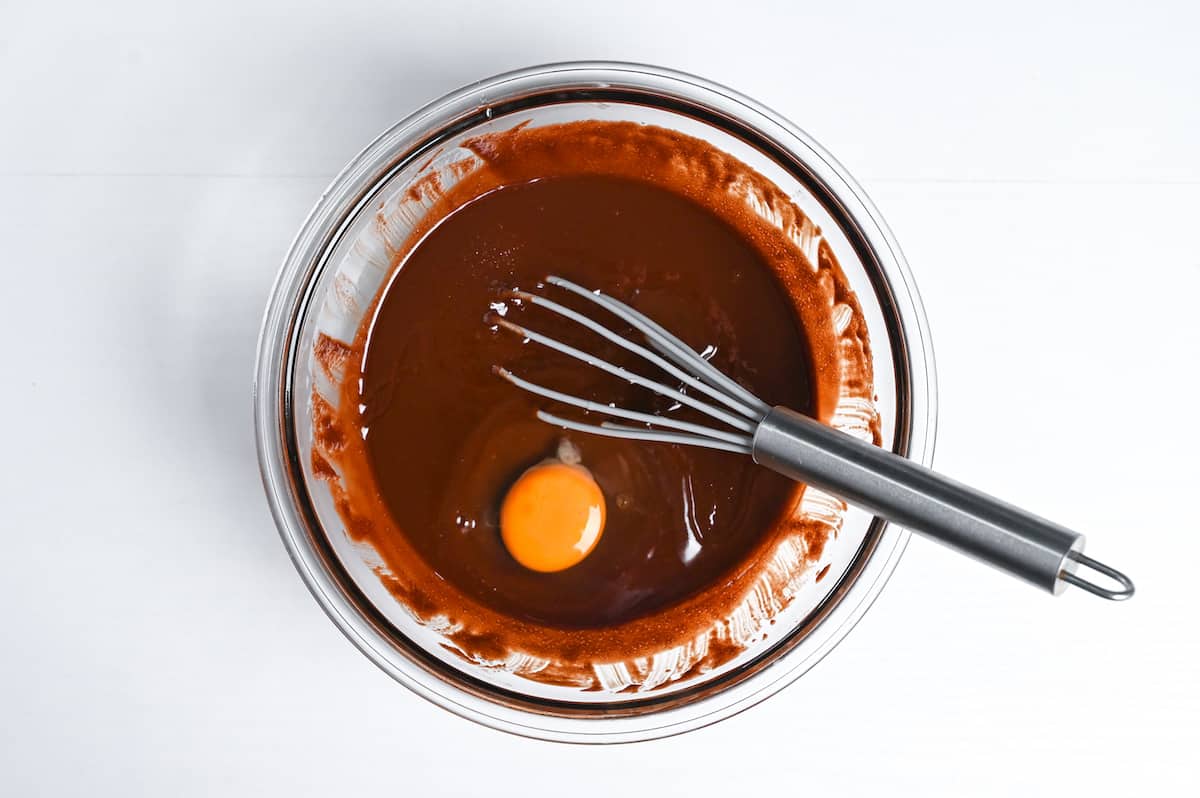 adding egg to cooled chocolate mixture