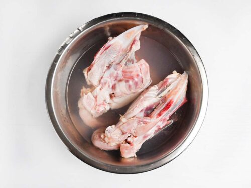 chicken carcass in bowl of water