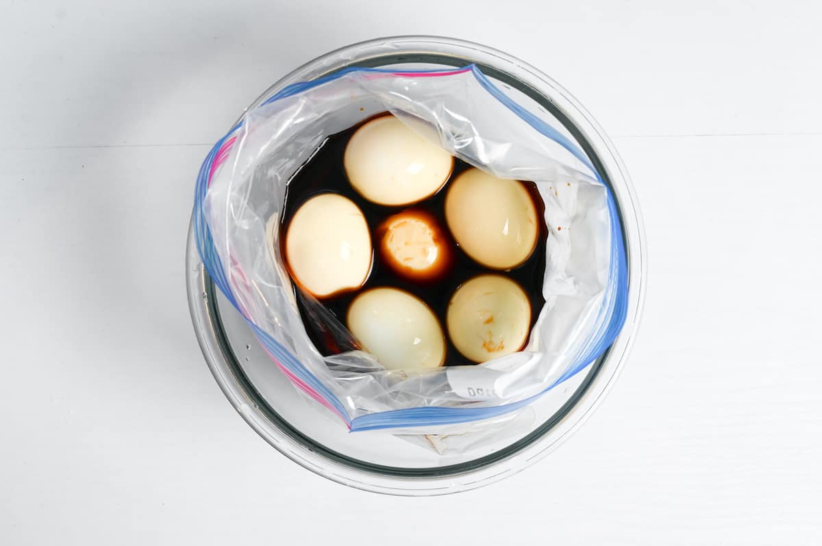 peeled eggs in a ziplock bag with ramen egg marinade