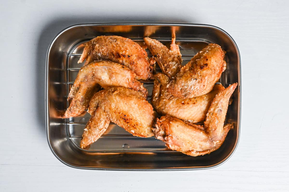 fried chicken wings resting on a wire rack