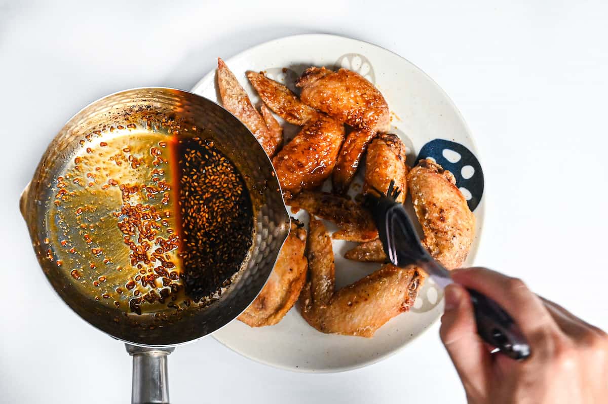 brushing fried chicken wings with yamachan style tebasaki sauce