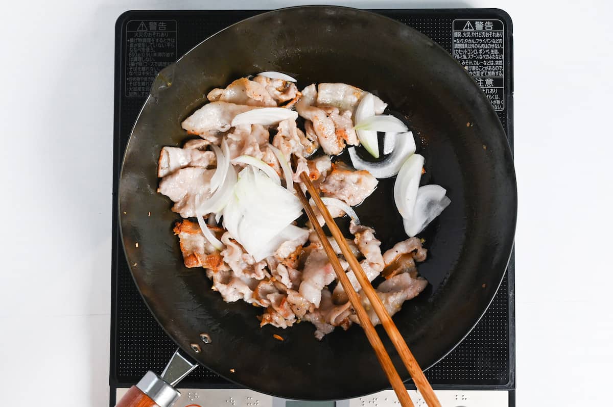 sliced onion added to fried pork